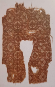 7. Fragment of a polychrome jin fabric which may be a shirt or a half-sleeved jacket.